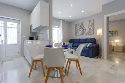 a kitchen and living room with a table and chairs at Apartamento Cádiz Mirador by Isa in Cádiz