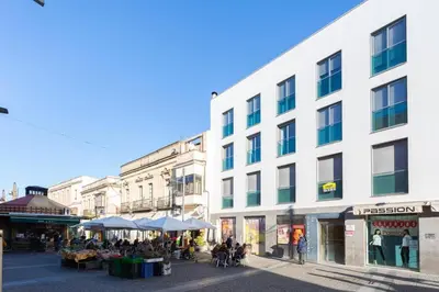 a group of people sitting in front of a building at Apartamento El Mercado - Ole Solutions in Jerez de la Frontera