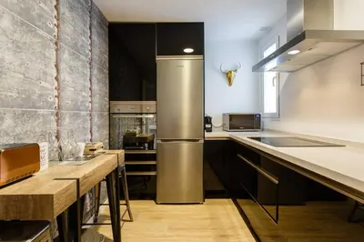 a kitchen with a stainless steel refrigerator and wooden counters at Apartamento El Mercado - Ole Solutions in Jerez de la Frontera