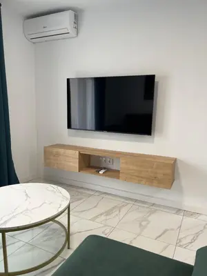 a living room with a flat screen tv on a wall at Mrati - Playa in Puerto Real