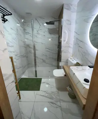 a bathroom with a shower and a toilet and a sink at Mrati - Playa in Puerto Real