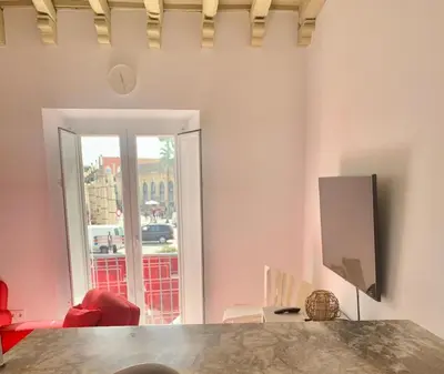 a living room with a table and a large window at Apartamento Gallo Azul in Jerez de la Frontera