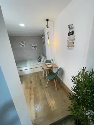 a room with a table and a bench in a room at Estudio BF jacuzzi jerez in Jerez de la Frontera