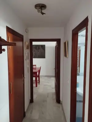 a hallway with two doors and a dining room at L' Alcoba Rooftop in Sanlúcar de Barrameda
