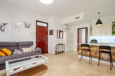 a living room with a couch and a table at CARPE DIEM in Jerez de la Frontera