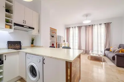 a kitchen and living room with a washing machine at CARPE DIEM in Jerez de la Frontera