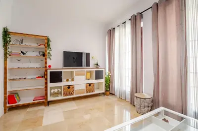 a living room with a tv on a shelf at CARPE DIEM in Jerez de la Frontera