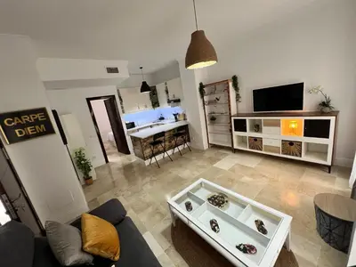 a living room with a couch and a table at CARPE DIEM in Jerez de la Frontera