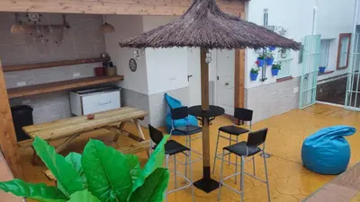 a kitchen with a table and chairs in a room at Apartamento Gitanilla in Chipiona