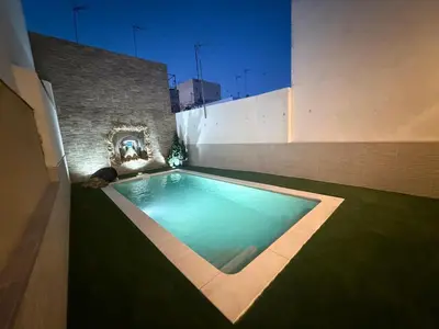 a shower in a bathroom with a stone wall at Apartamento Gitanilla in Chipiona