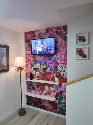 a living room with a wall covered in flowers at Apartamento Gitanilla in Chipiona