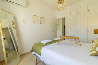 a bedroom with a bed with a table on it at Allo Apartments Arroyo Ático Parking Centro 1 Habitación in Jerez de la Frontera