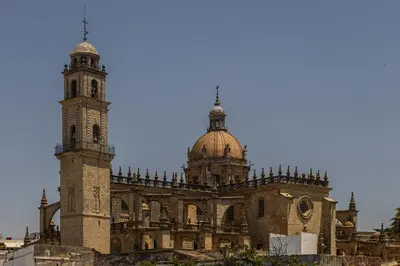 a large building with a clock tower on top at Allo Apartments Arroyo Ático Parking Centro 1 Habitación in Jerez de la Frontera