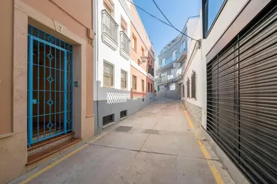 an empty street with a building with glass doors at Loving Rota in Rota