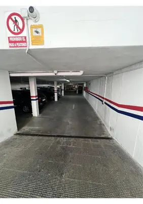 an empty parking garage with cars parked in it at Sherry-House & Parking in Jerez de la Frontera