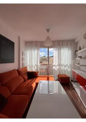 a living room with a couch and a glass table at Sherry-House & Parking in Jerez de la Frontera