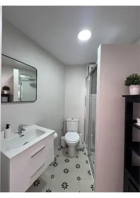 a bathroom with a toilet and a sink and a mirror at Sherry-House & Parking in Jerez de la Frontera