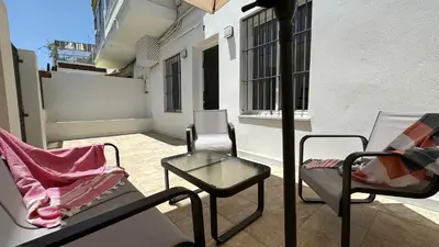 a balcony with chairs and a table on a building at SIBS Sanlúcar Guadalquivir I - TERRAZA in Sanlúcar de Barrameda