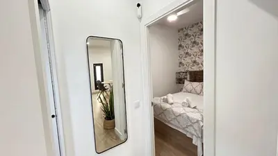 a mirror in a small room with a bed at SIBS Sanlúcar Guadalquivir 2 Coqueto Ideal Parejas in Sanlúcar de Barrameda