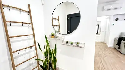 a hallway with a mirror and a plant at SIBS Sanlúcar Guadalquivir 2 Coqueto Ideal Parejas in Sanlúcar de Barrameda