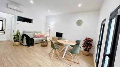 a living room with a table and chairs and a couch at SIBS Sanlúcar Guadalquivir 2 Coqueto Ideal Parejas in Sanlúcar de Barrameda
