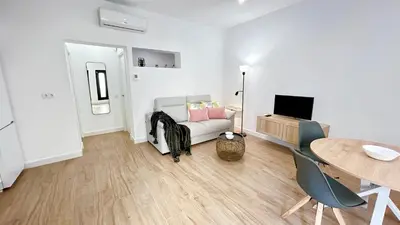 a living room with a couch and a table at SIBS Sanlúcar Guadalquivir 2 Coqueto Ideal Parejas in Sanlúcar de Barrameda