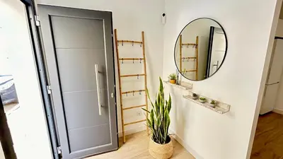 a bathroom with a door and a mirror at SIBS Sanlúcar Guadalquivir 2 Coqueto Ideal Parejas in Sanlúcar de Barrameda