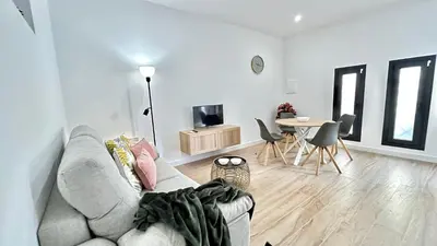 a living room with a couch and a table at SIBS Sanlúcar Guadalquivir 2 Coqueto Ideal Parejas in Sanlúcar de Barrameda