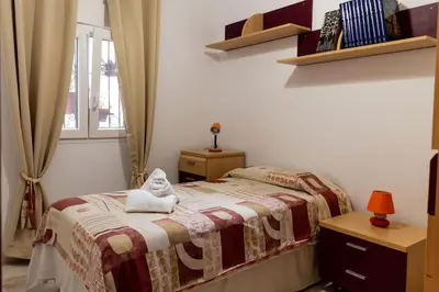 a bedroom with a bed with a stuffed animal on it at El Patio de la Viña by Gades Gestión in Cádiz