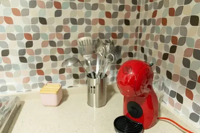 a red mixer sitting on a counter in a kitchen at El Patio de la Viña by Gades Gestión in Cádiz