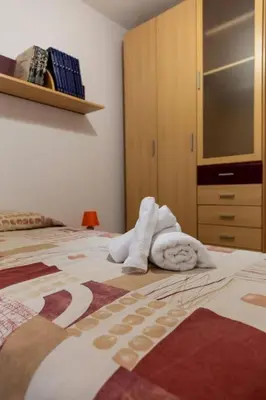 a bedroom with a bed with towels on it at El Patio de la Viña by Gades Gestión in Cádiz