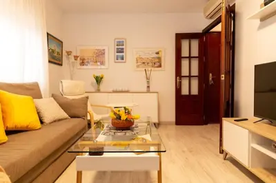 a living room with a couch and a coffee table at El Patio de la Viña by Gades Gestión in Cádiz