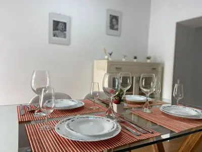 a table with wine glasses and plates on it at TU ESCONDITE in Jerez de la Frontera