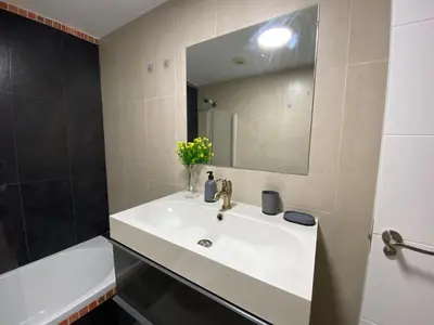 a bathroom with a sink and a mirror at TU ESCONDITE in Jerez de la Frontera