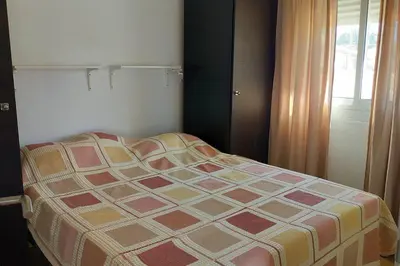 a bed sitting in a bedroom with a window at Casita café in Chiclana de la Frontera