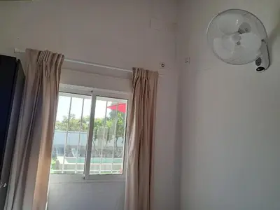 a room with a window and a fan at Casita café in Chiclana de la Frontera