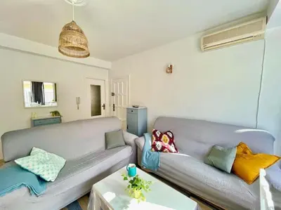 a living room with a couch and a table at Apartamento ZIUREV IV in Sanlúcar de Barrameda