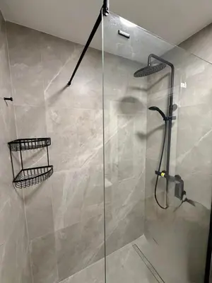 a shower with a glass door in a bathroom at Apartamento ZIUREV IV in Sanlúcar de Barrameda