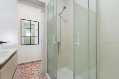 a glass shower in a bathroom with a sink at Manolete apartamento in Jerez de la Frontera