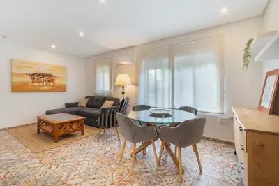 a living room with a table and a couch at Manolete apartamento in Jerez de la Frontera