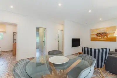 a living room with a glass table and chairs at Manolete apartamento in Jerez de la Frontera