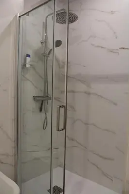 a shower in a bathroom with a glass door at Villa Marcel in Jerez de la Frontera