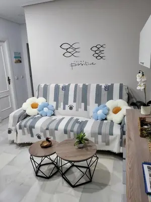 a living room with a couch and a table at Apartamento Pinar del Atlántico La Barrosa in Chiclana de la Frontera