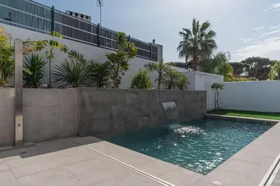 a swimming pool in front of a building at VILLA caracolillo MAR in Chiclana de la Frontera