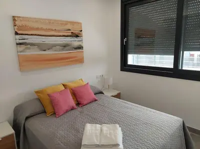 a bedroom with a bed with two towels on it at VILLA caracolillo MAR in Chiclana de la Frontera