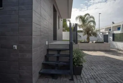 a building with stairs on the side of it at VILLA caracolillo MAR in Chiclana de la Frontera