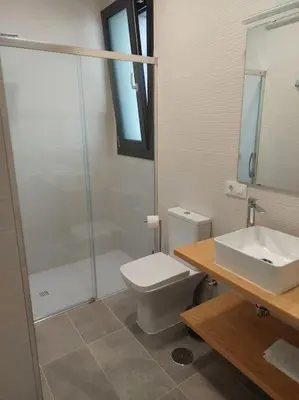 a bathroom with a shower and a toilet and a sink at VILLA caracolillo MAR in Chiclana de la Frontera