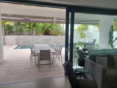 a living room with a table and chairs at VILLA caracolillo MAR in Chiclana de la Frontera