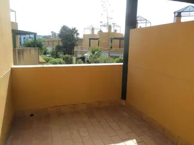a room with a yellow wall and a tile floor at Casa Tartessos in Costa Ballena