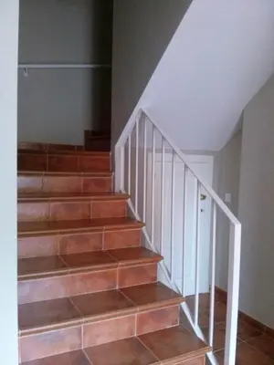 a staircase with wooden steps and white rail at Casa Tartessos in Costa Ballena